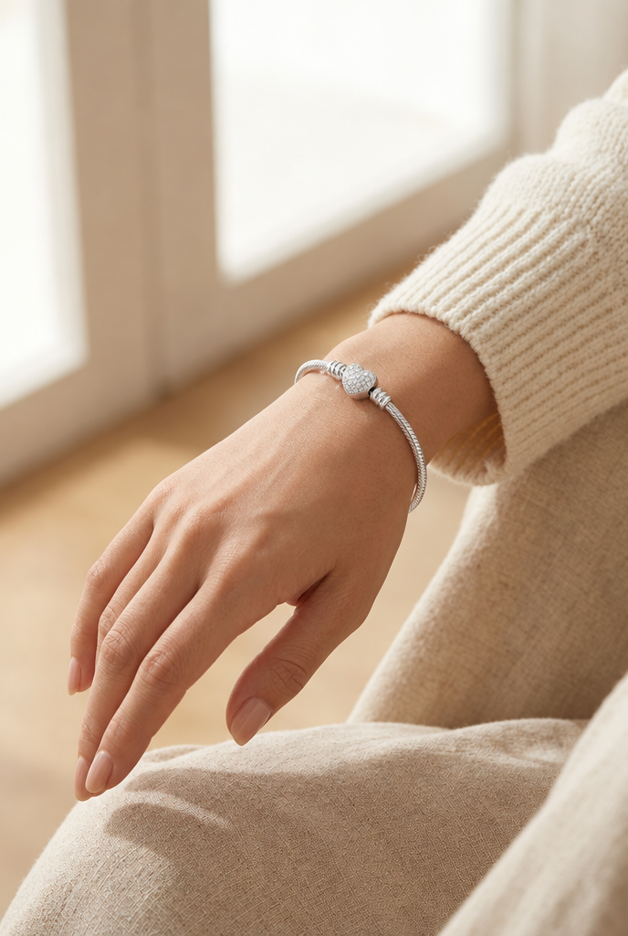 Heart clasp bracelet worn on the wrist in soft daylight