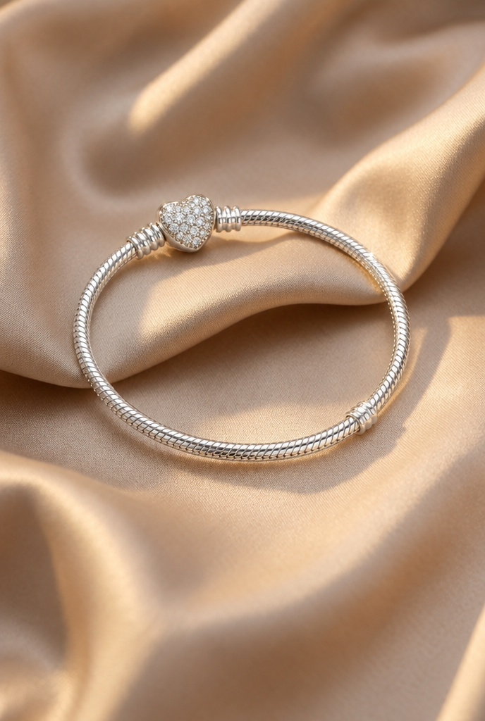 Heart clasp bracelet on draped champagne silk