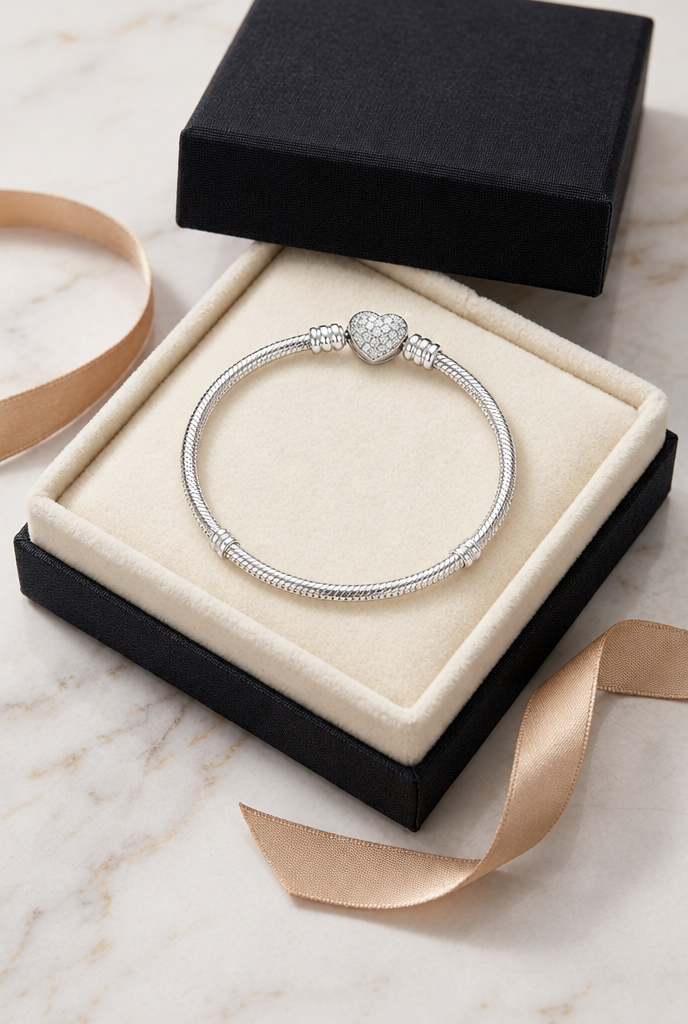 Heart clasp bracelet resting in an open gift box