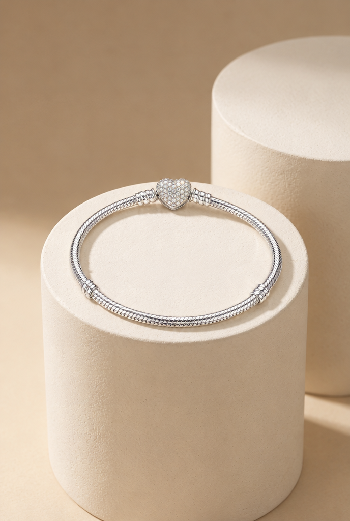 Heart clasp bracelet displayed on a stone pedestal